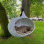 unknown nordic "Bios Hide Hanging lounger" in Weiß mit Kissen an einem Baum
